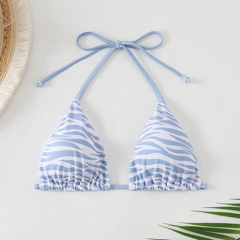 The Zebra Noir Padded Halter Bikini Top in blue zebra print, featuring adjustable ties and flattering design.