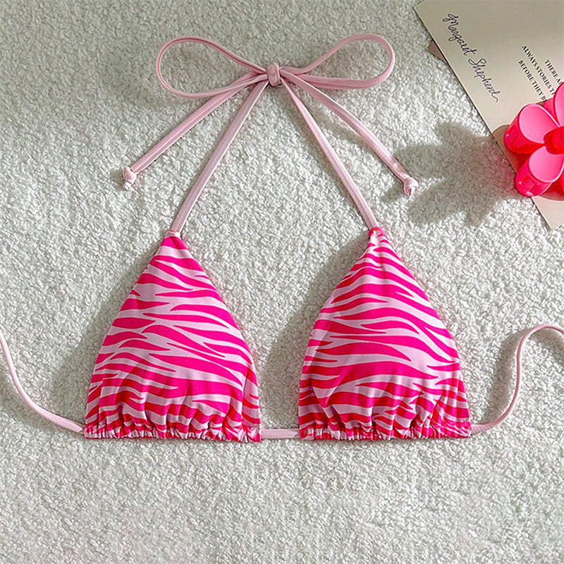 The Zebra Noir Padded Halter Bikini Top in vibrant pink zebra print with adjustable ties.