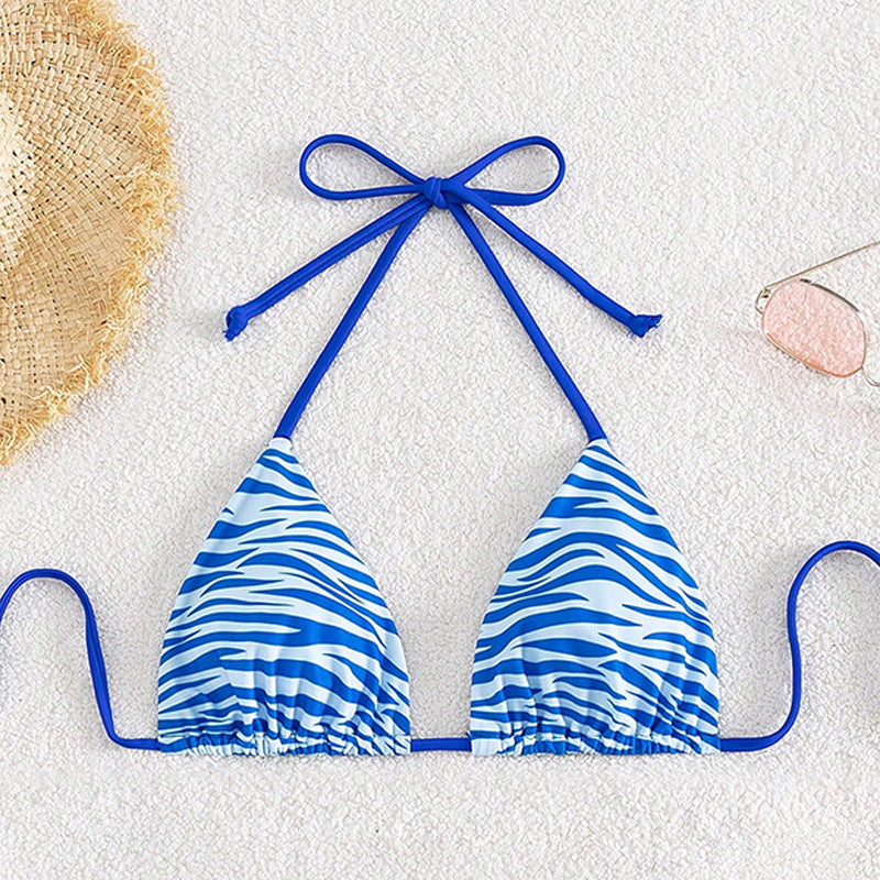 The Zebra Noir Padded Halter Bikini Top featuring a striking blue zebra print design.